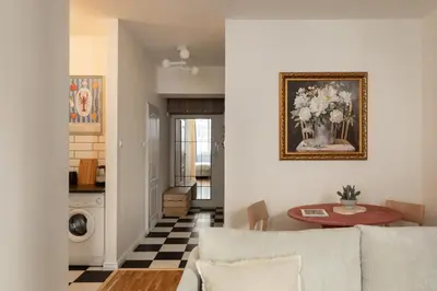 a living room with a couch and a table at Prestigious Main Square Apartment in Kraków
