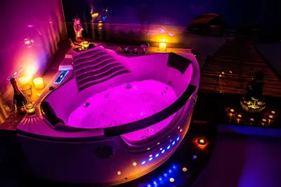 a hot tub in a room with purple lights at Jacuzzi Apartment Zen in Kraków