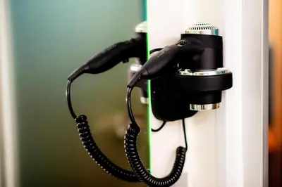 a black phone hanging on a door handle at Jacuzzi Apartment Zen in Kraków