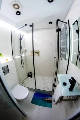 a bathroom with a shower and a toilet at Jacuzzi Apartment Zen in Kraków