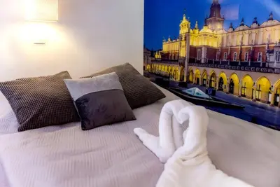 a hotel room with a bed with a towel on it at Apartment Brzozowa in Kraków