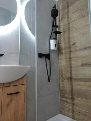 a bathroom with a shower and a sink at Apartment Brzozowa in Kraków