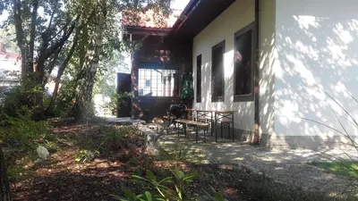 a porch of a house with a table and chairs at Eko Dom Eturia in Suchoraba