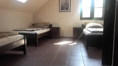 a room with three beds and a window at Eko Dom Eturia in Suchoraba