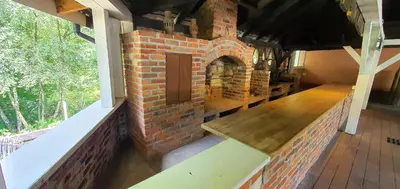 a brick fireplace in a house with a door at Hotel Zajazd Celtycki in Zakrzów