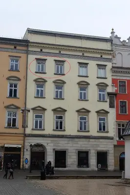 a large building with a red circle on it at Market Square Residence in Kraków