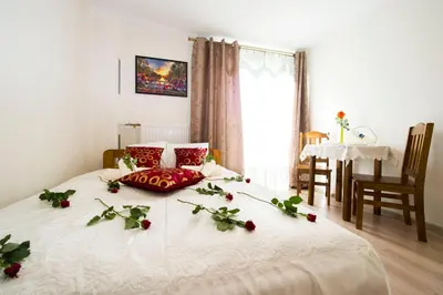 a bedroom with a bed with flowers on it at Królewski Apartament in Kraków
