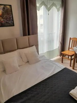 a bed in a bedroom with a large window at Królewski Apartament in Kraków