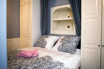 a small bed in a room with two pillows at Royal Residence by OTR in Kraków