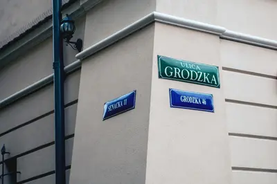 two street signs on the side of a building at Royal Residence by OTR in Kraków