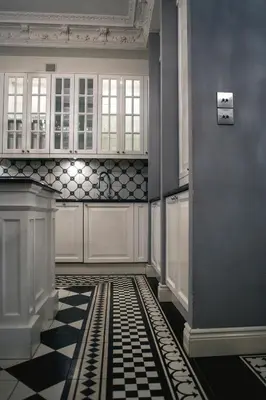 a kitchen with a black and white checkered floor at Royal Residence by OTR in Kraków