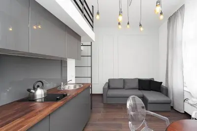 a kitchen with a sink and a couch in a room at 2 Nights Apartments - great location, right next to Main Rail and Bus Station, 10 min to Main Square by foot in Kraków