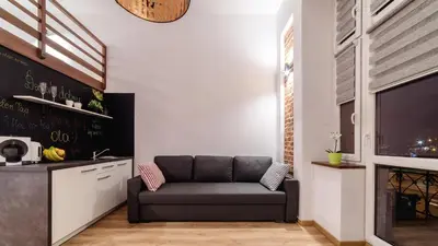 a living room with a couch and a tv at 2 Nights Apartments - great location, right next to Main Rail and Bus Station, 10 min to Main Square by foot in Kraków