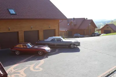 two old cars parked in front of a garage at Fantastic View Vineyard Beskid Mountains in Gruszów