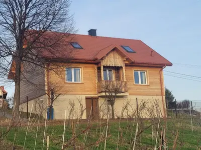a wooden house with a red roof at Fantastic View Vineyard Beskid Mountains in Gruszów
