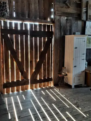 a barn door in a room with wooden walls at Gospodarstwo Gościnne Księżycówka in Rajbrot