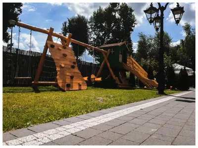 a playground in a park with a slide at Hotel Dąbrowski in Oświęcim