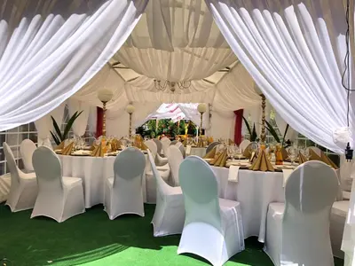a marquee with tables and chairs and white drapes at Hotel Dąbrowski in Oświęcim