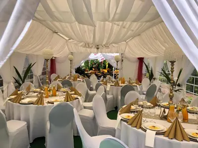 a marquee set up for a wedding with white tables and chairs at Hotel Dąbrowski in Oświęcim