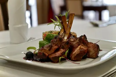 a plate of food with meat on a table at Hotel Dąbrowski in Oświęcim