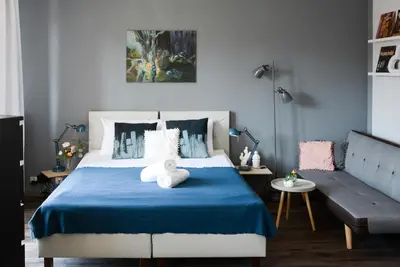 a bedroom with a bed with a stuffed animal on it at Vinyl Apartment Old Town in Kraków