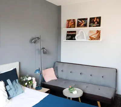 a bedroom with a couch and a bed and a table at Vinyl Apartment Old Town in Kraków