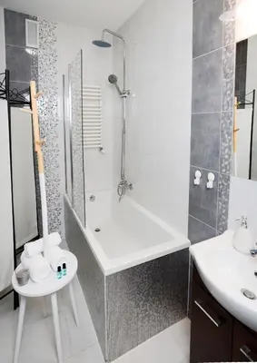 a bathroom with a shower and a tub and a sink at Vinyl Apartment Old Town in Kraków