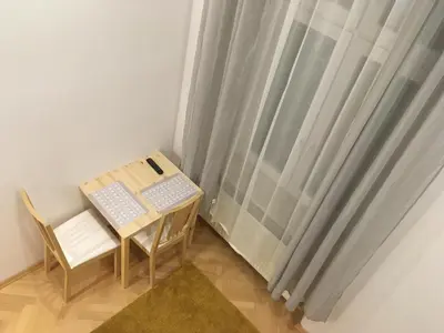 a small table and chair next to a window at City Space Apartments in Kraków