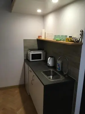 a small kitchen with a sink and a microwave at City Space Apartments in Kraków