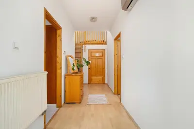 a hallway with wooden floors and a door at Sunshine apartment in Kraków