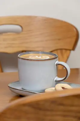 a cup of coffee sitting on a table at Sunshine apartment in Kraków