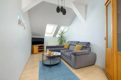 a living room with a couch and a table at Sunshine apartment in Kraków