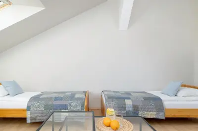 a room with two beds and a glass table at Sunshine apartment in Kraków