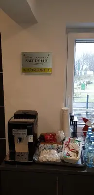 a counter with a box of food and a sign on the wall at Apartamenty Salt Delux in Wieliczka