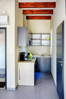 a kitchen with blue cabinets and a blue door at Apartamenty Salt Delux in Wieliczka