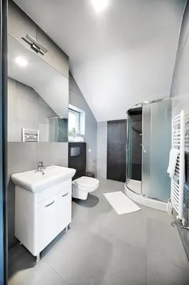 a bathroom with a sink and a toilet at Apartamenty Salt Delux in Wieliczka