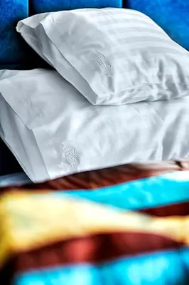 a close up of a white pillow on a bed at Apartamenty Salt Delux in Wieliczka