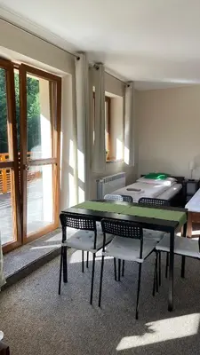 a room with a table and four chairs and a window at Górskie Zacisze in Zawoja