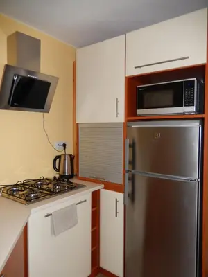a kitchen with a stainless steel refrigerator and microwave at Górskie Zacisze in Zawoja