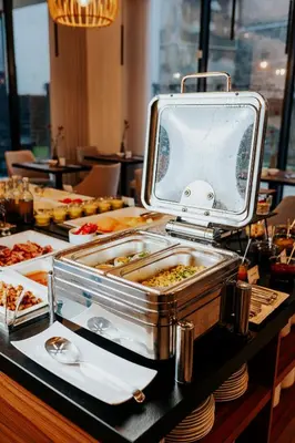 a buffet of food on a table in a restaurant at Grand Ascot Hotel in Kraków