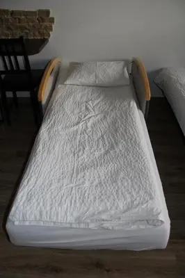a unmade bed with white sheets and pillows at Apartment Wielicka Cracow in Kraków