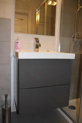a bathroom counter with a sink and a shower at Apartment Wielicka Cracow in Kraków
