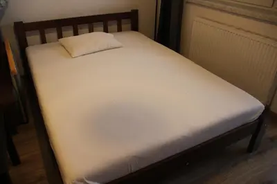 a white bed with a pillow on top of it at Apartment Wielicka Cracow in Kraków