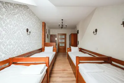 a hospital room with three beds in it at Ginger ApartHostel in Kraków