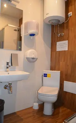 a bathroom with a toilet and a sink at Ginger ApartHostel in Kraków