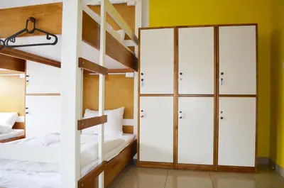 a bunk bed room with two bunk beds and a ladder at Ginger ApartHostel in Kraków