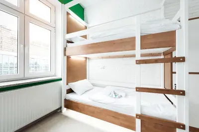a room with a bunk bed and a window at Ginger ApartHostel in Kraków