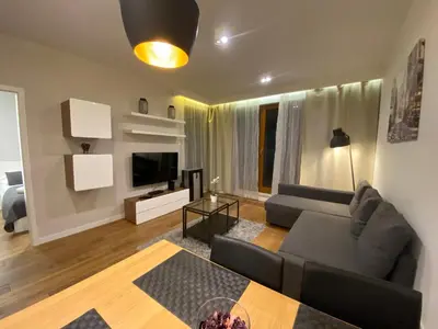 a living room with a couch and a table at P&J Apartments Lubicz in Kraków