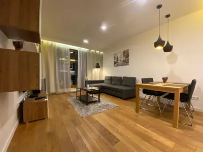 a living room with a table and a couch at P&J Apartments Lubicz in Kraków