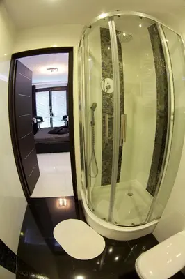 a bathroom with a shower with a toilet and a mirror at Angel City MARCO in Kraków